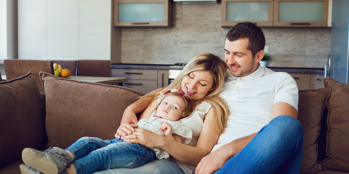 2 Happy man, woman and child on sofa